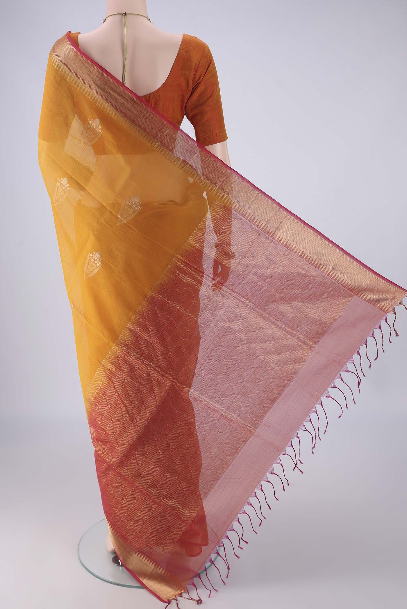 Flat view of Mustard Kora Cotton Saree with Zari Butta on the body and Zari Border. 