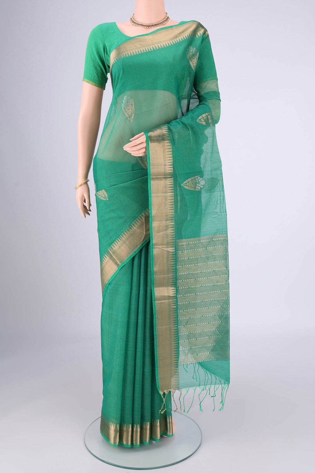 Teal Silk Cotton Saree with Zari Butta on the body and Zari Border.  displayed on a mannequin