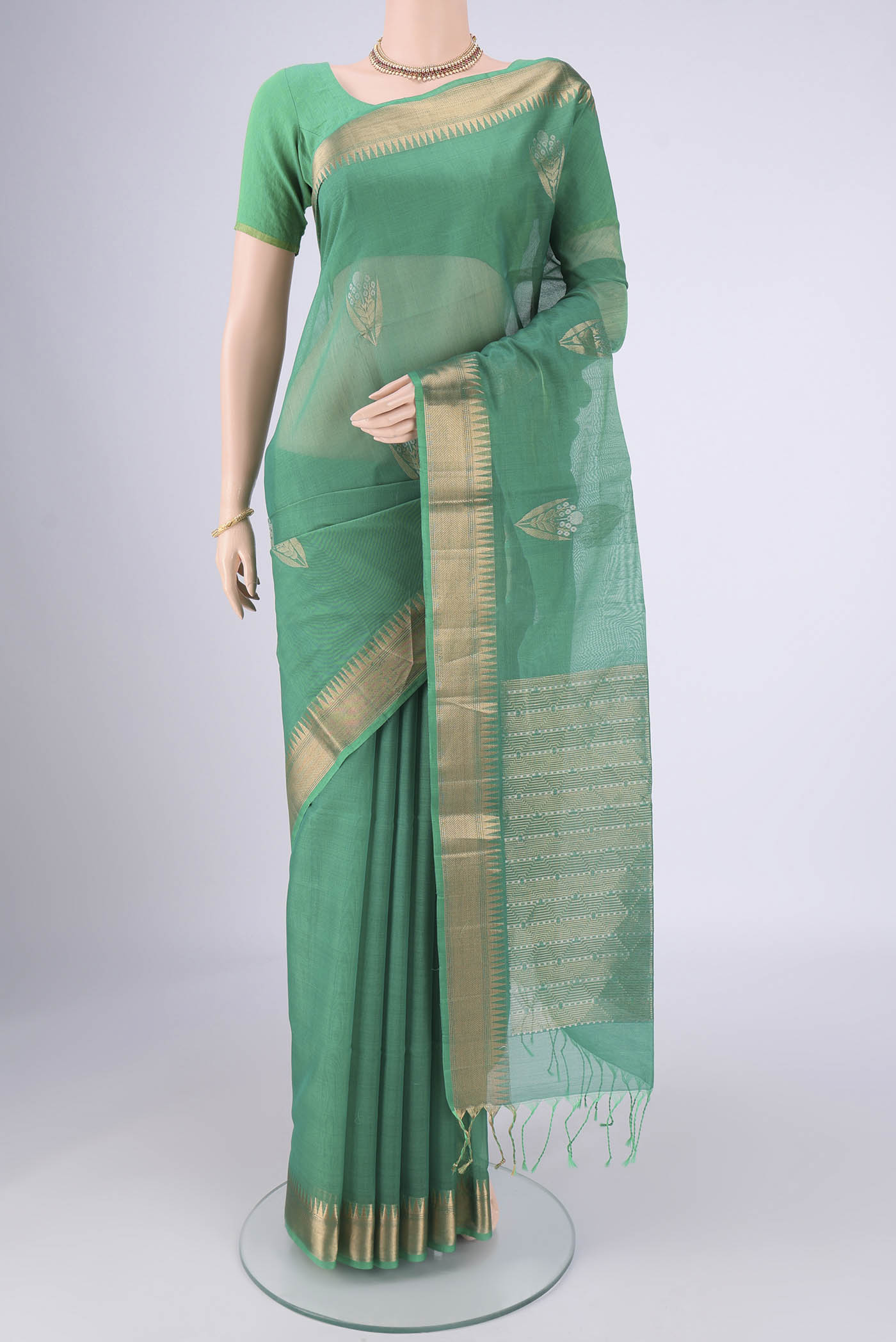 Teal Silk Cotton Saree with Zari Butta on the body and Zari Border.  displayed on a mannequin
