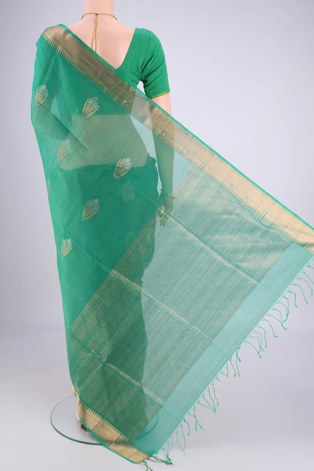 Flat view of Teal Silk Cotton Saree with Zari Butta on the body and Zari Border. 