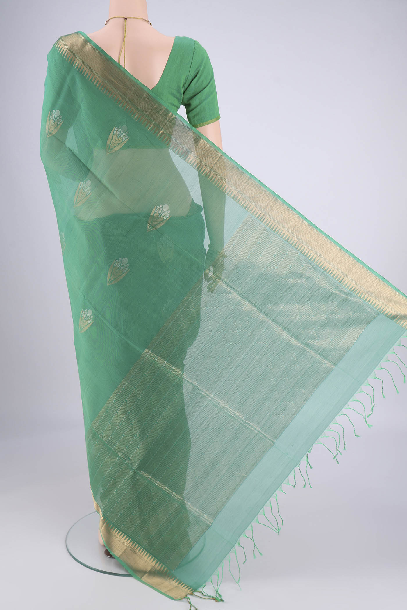 Flat view of Teal Silk Cotton Saree with Zari Butta on the body and Zari Border. 