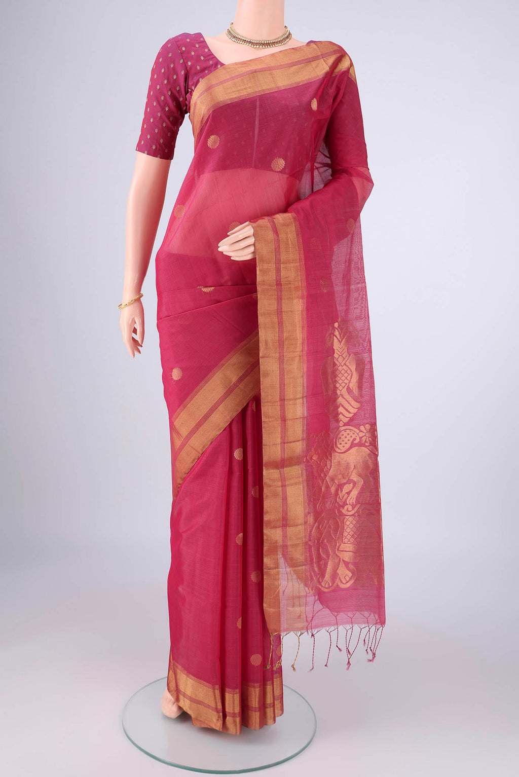 Pink Silk Cotton Saree with Zari Butta on the body and Zari Border.  displayed on a mannequin