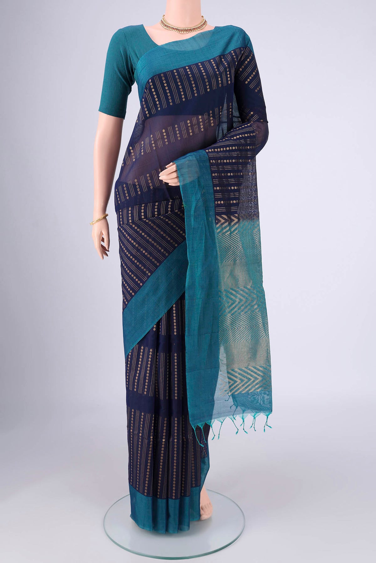 Navy Blue Silk Cotton Saree with Zari Butta on the body and Plain Border.  displayed on a mannequin