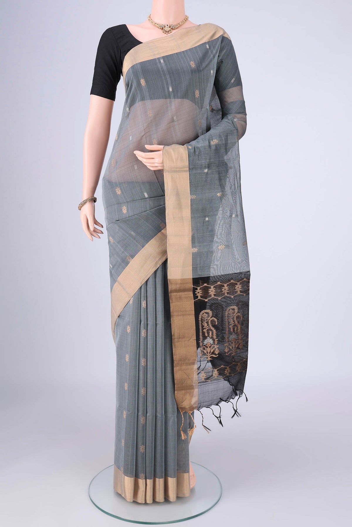 Grey Silk Cotton Saree with Zari Butta on the body and Zari Border.  displayed on a mannequin
