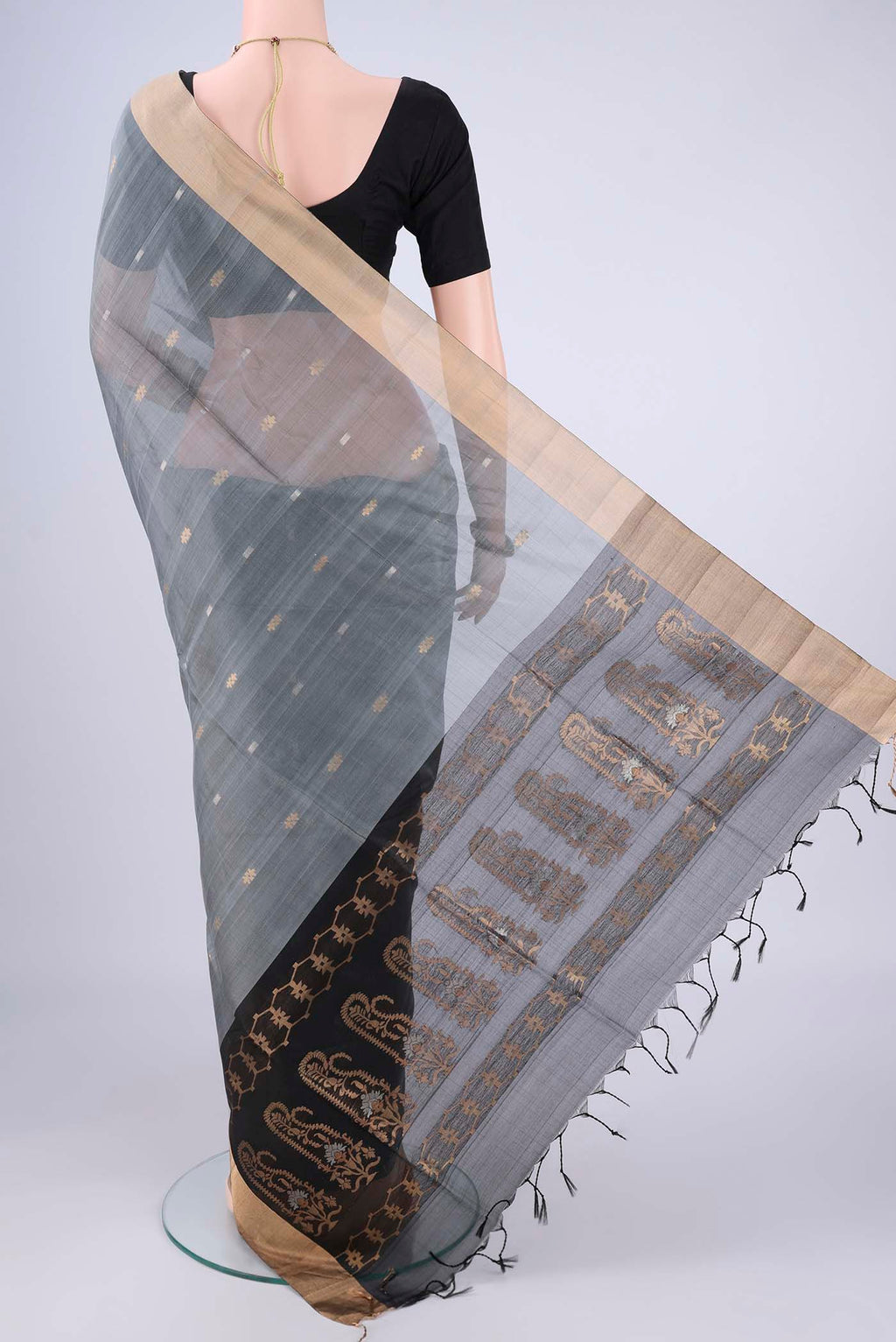 Flat view of Grey Silk Cotton Saree with Zari Butta on the body and Zari Border. 