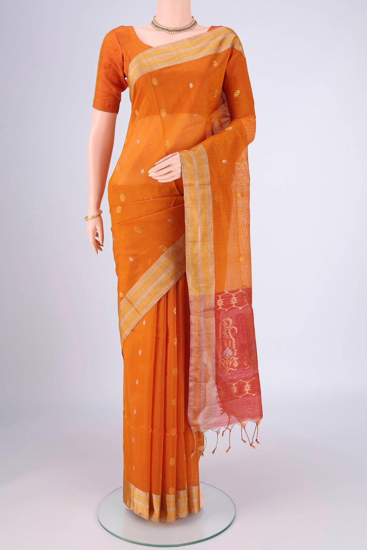 Mustard Silk Cotton Saree with Zari Butta on the body and Zari Border.  displayed on a mannequin
