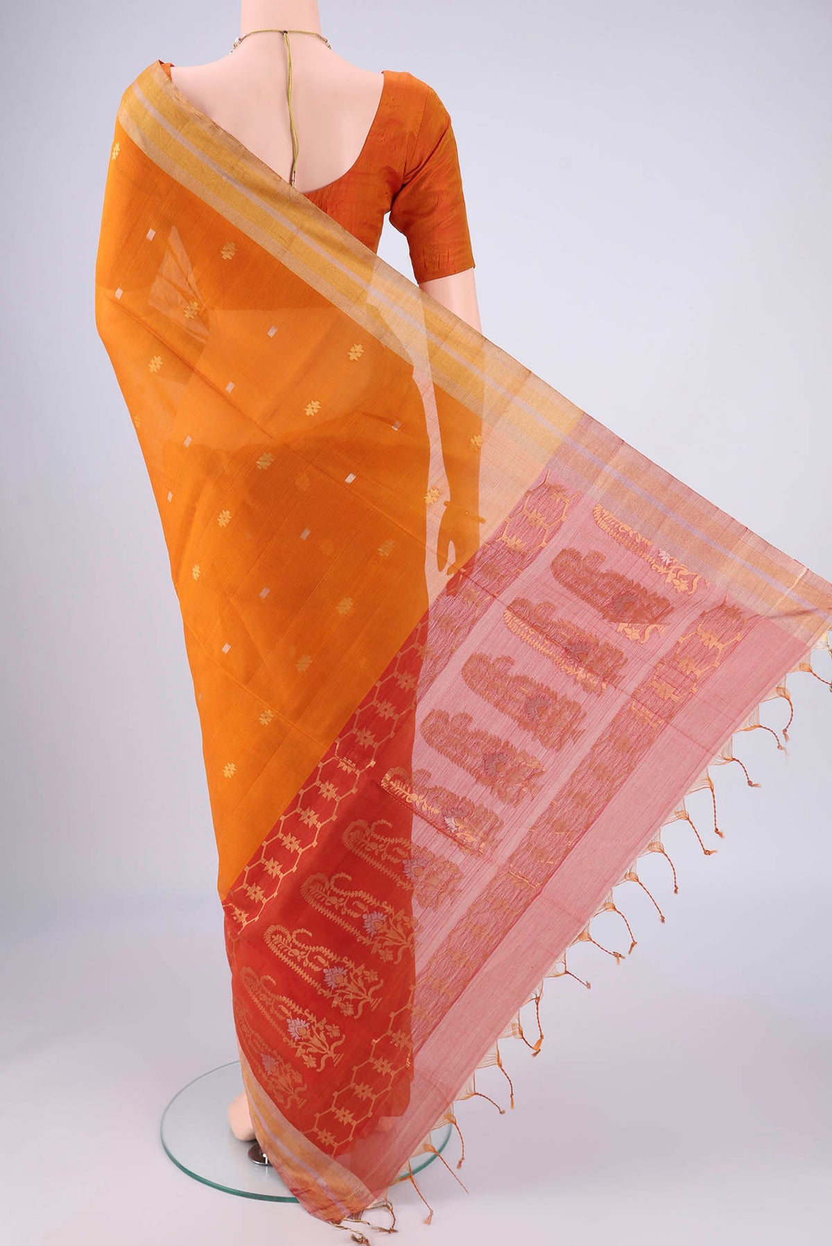 Flat view of Mustard Silk Cotton Saree with Zari Butta on the body and Zari Border. 
