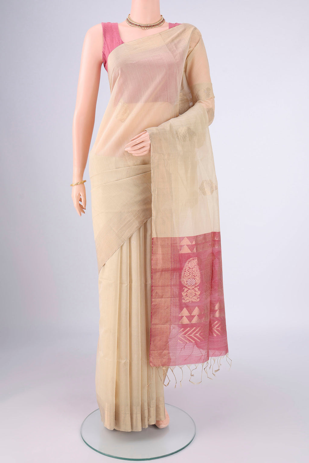 Beige Silk Cotton Saree with Zari Butta on the body and Zari Border.  displayed on a mannequin