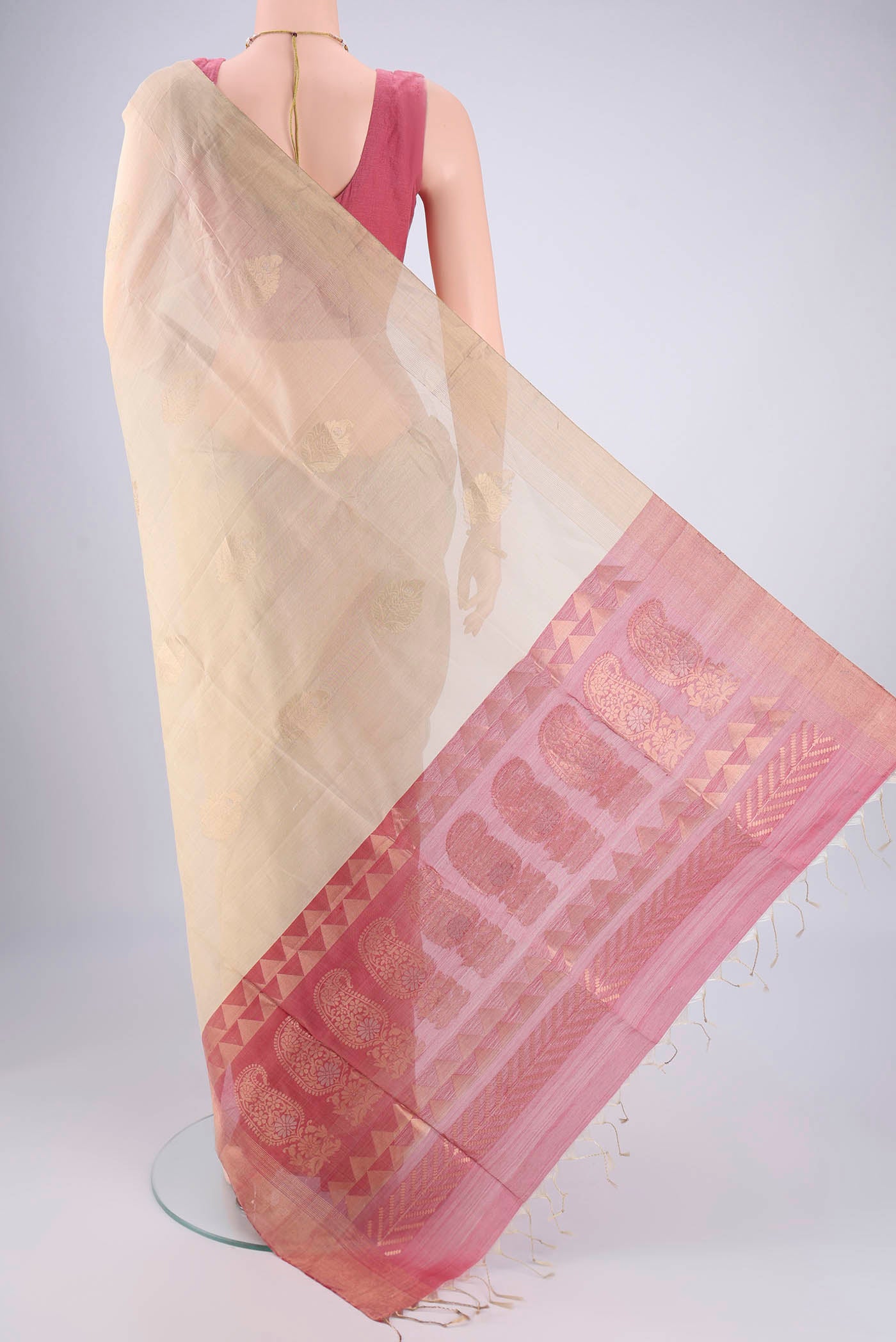 Flat view of Beige Silk Cotton Saree with Zari Butta on the body and Zari Border. 