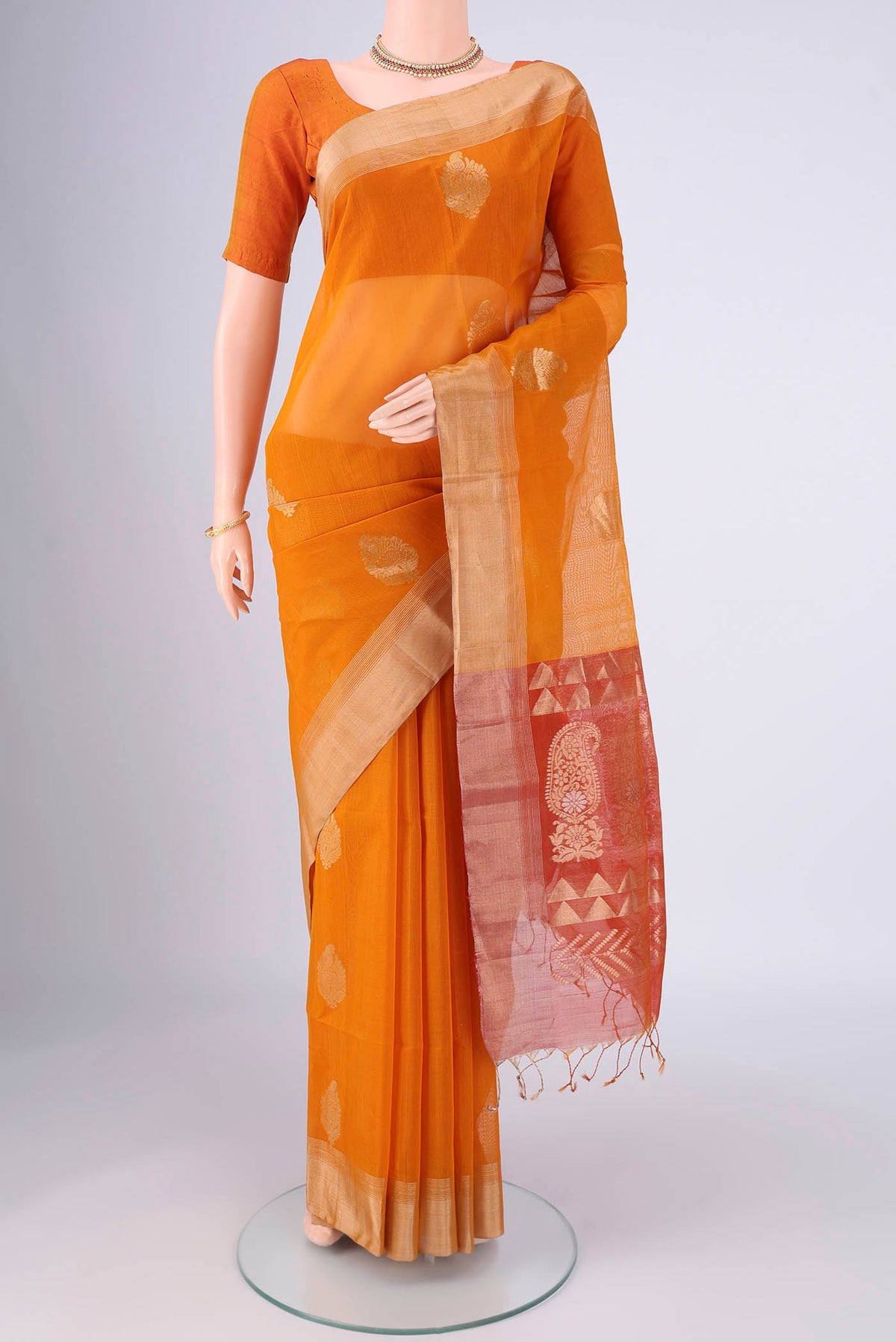 Mustard Silk Cotton Saree with Zari Butta on the body and Zari Border.  displayed on a mannequin