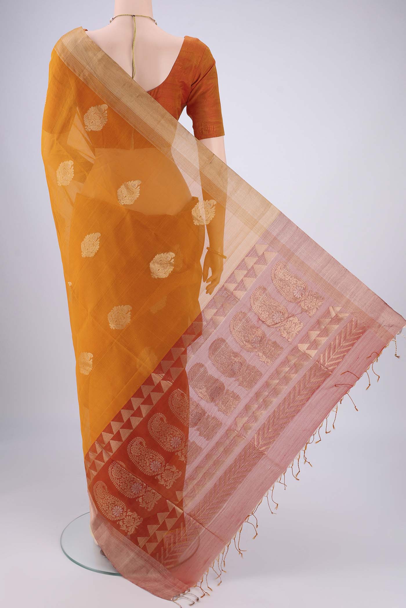 Flat view of Mustard Silk Cotton Saree with Zari Butta on the body and Zari Border. 