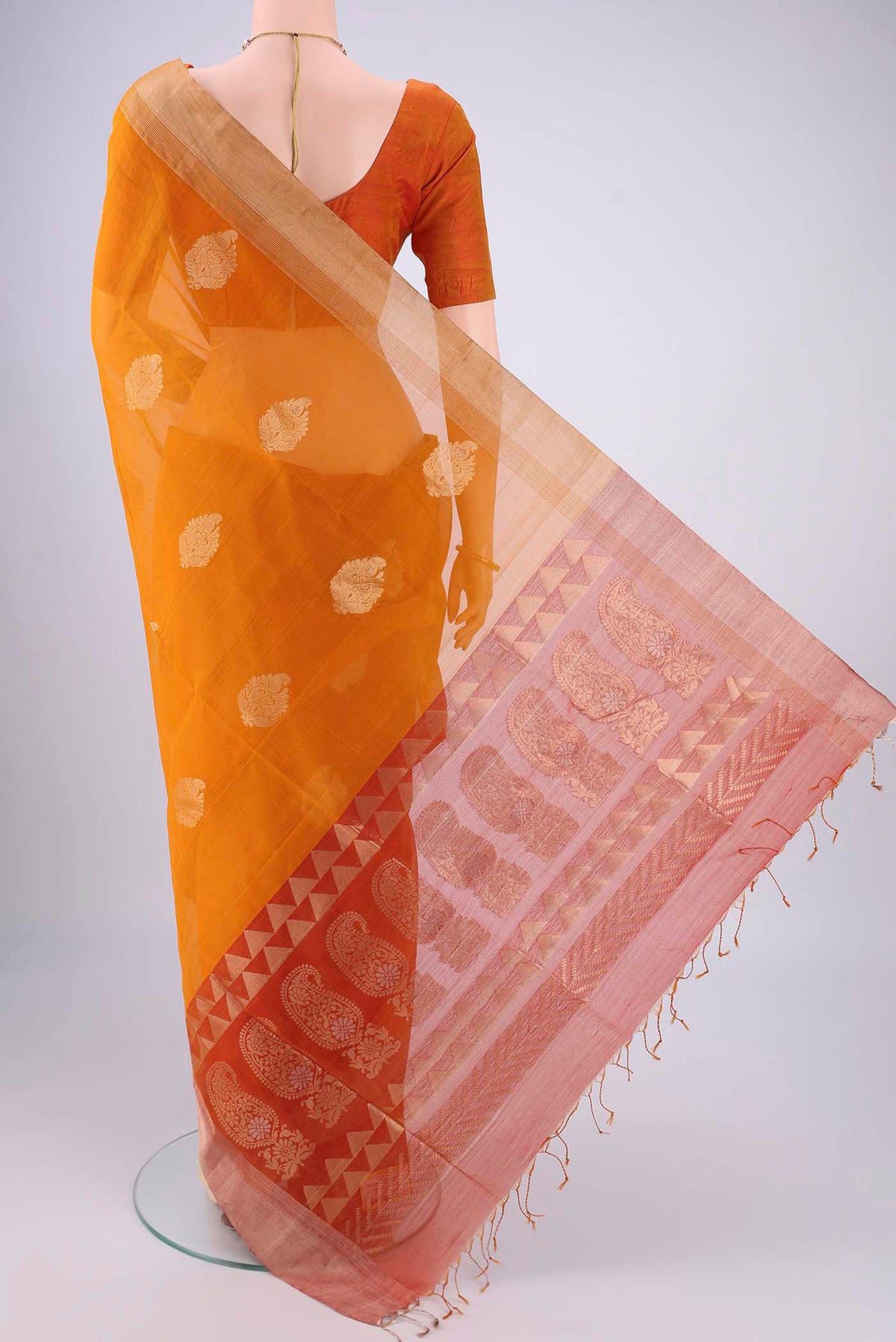 Flat view of Mustard Silk Cotton Saree with Zari Butta on the body and Zari Border. 