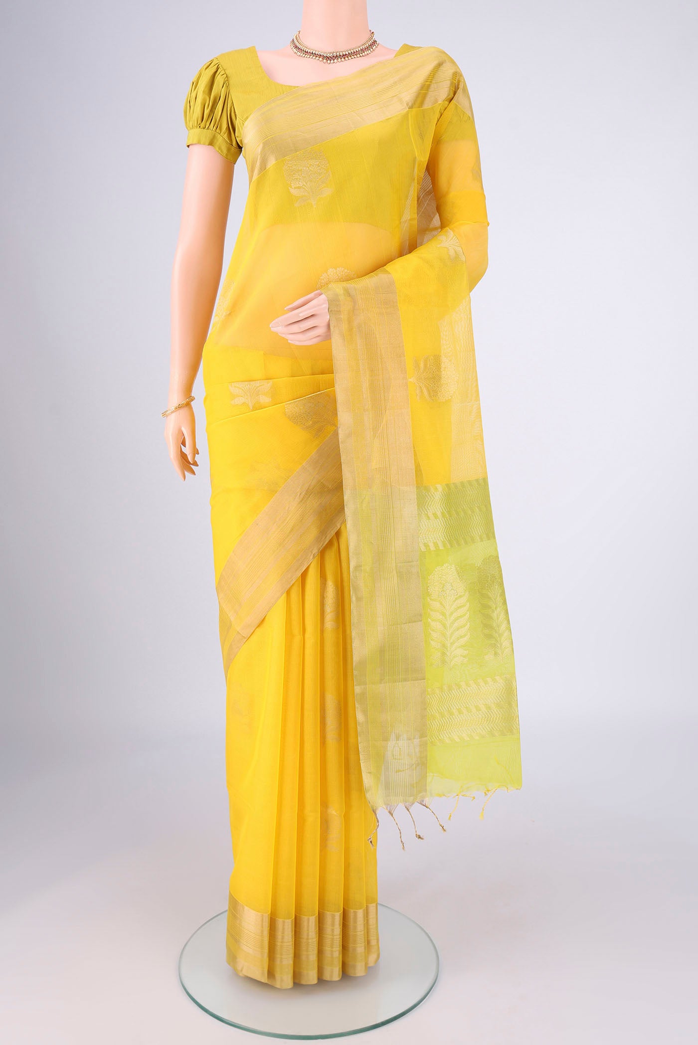 Yellow Silk Cotton Saree with Zari Butta on the body and Zari Border.  displayed on a mannequin
