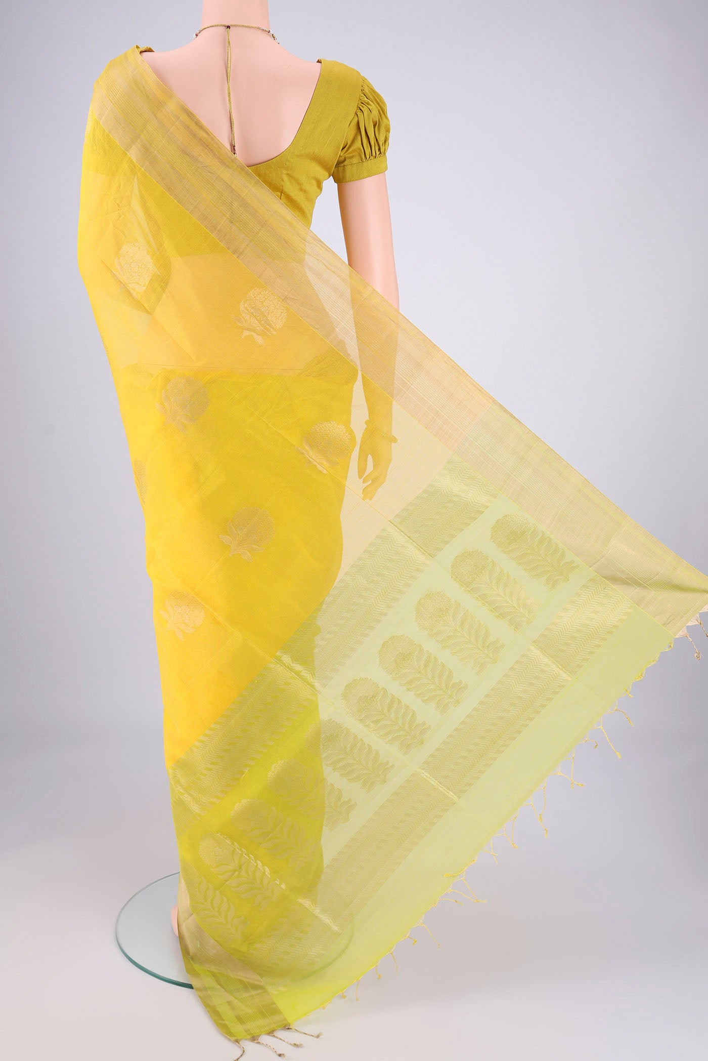 Flat view of Yellow Silk Cotton Saree with Zari Butta on the body and Zari Border. 