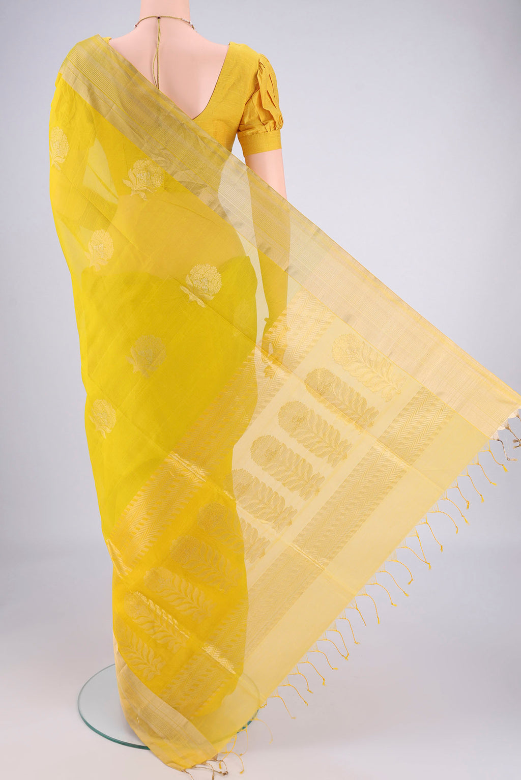 Flat view of Green Silk Cotton Saree with Zari Butta on the body and Zari Border. 