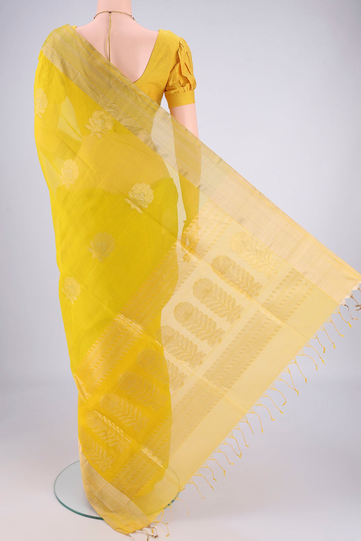 Flat view of Green Silk Cotton Saree with Zari Butta on the body and Zari Border. 