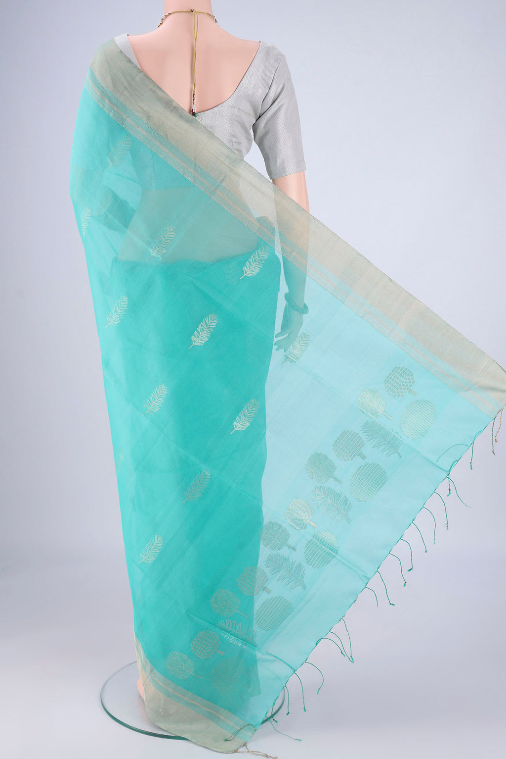 Flat view of Light Blue Silk Cotton Saree with Zari Butta on the body and Zari Border. 
