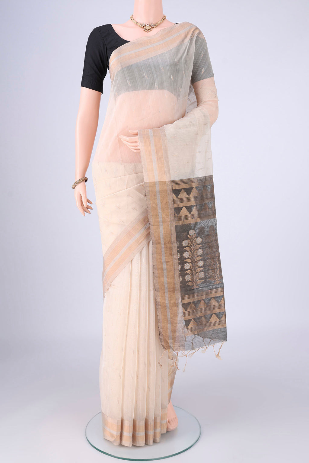 Cream Silk Cotton Saree with Zari Butta on the body and Zari Border.  displayed on a mannequin