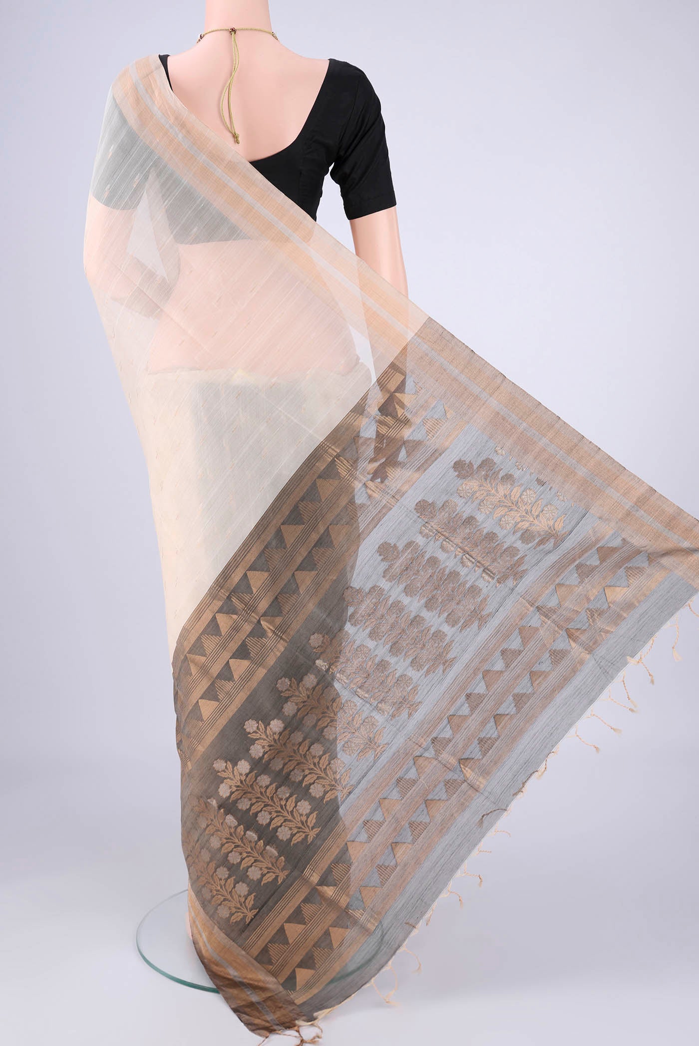 Flat view of Cream Silk Cotton Saree with Zari Butta on the body and Zari Border. 