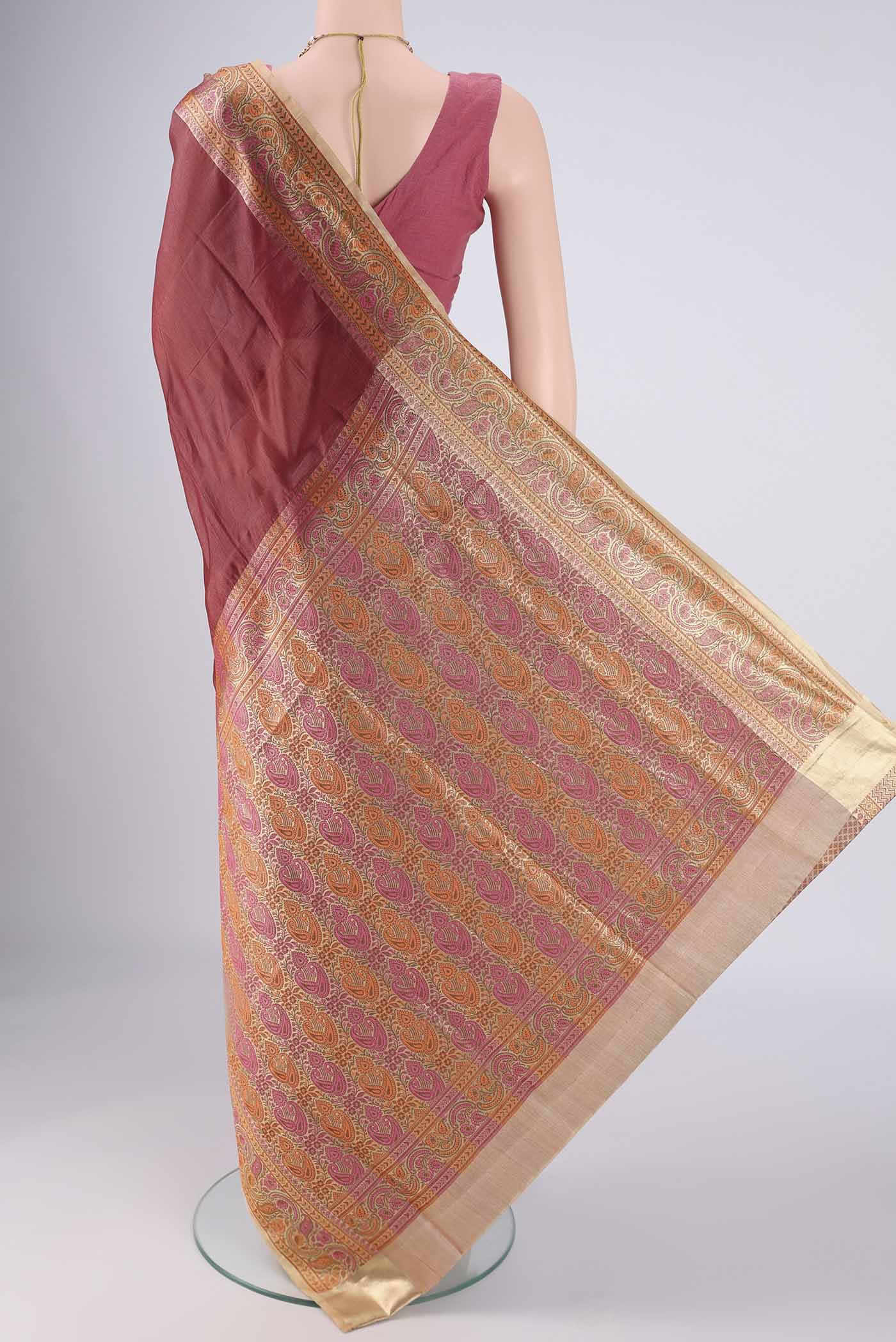 Flat view of Brown Banarasi Tussar Silk Saree with Plain Body and Zari Border. 