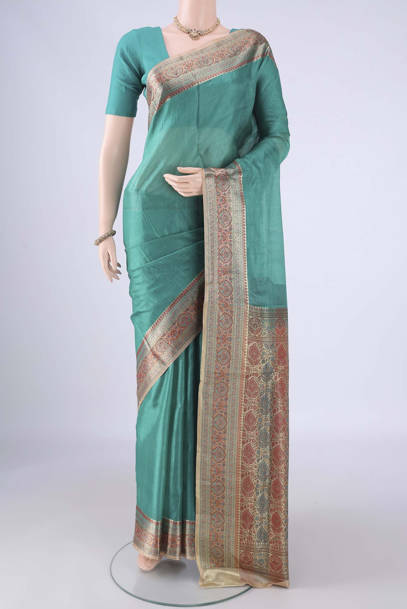Sea Green Banarasi Tussar Silk Saree with Plain Body and Zari Border.  displayed on a mannequin