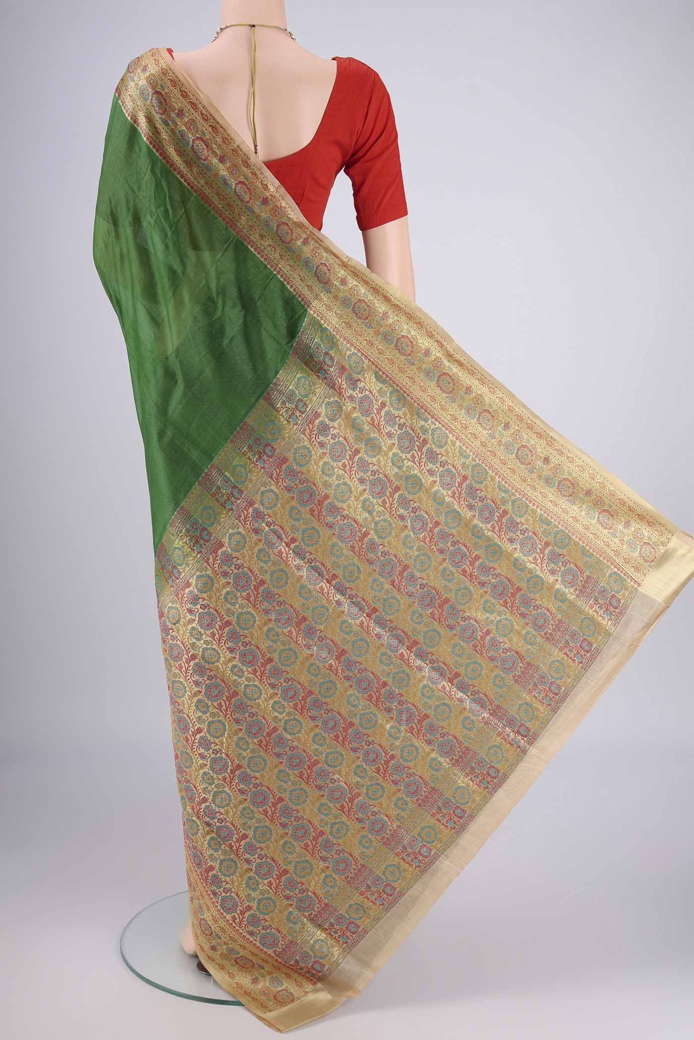 Flat view of Green Banarasi Tussar Silk Saree with Plain Body and Zari Border. 