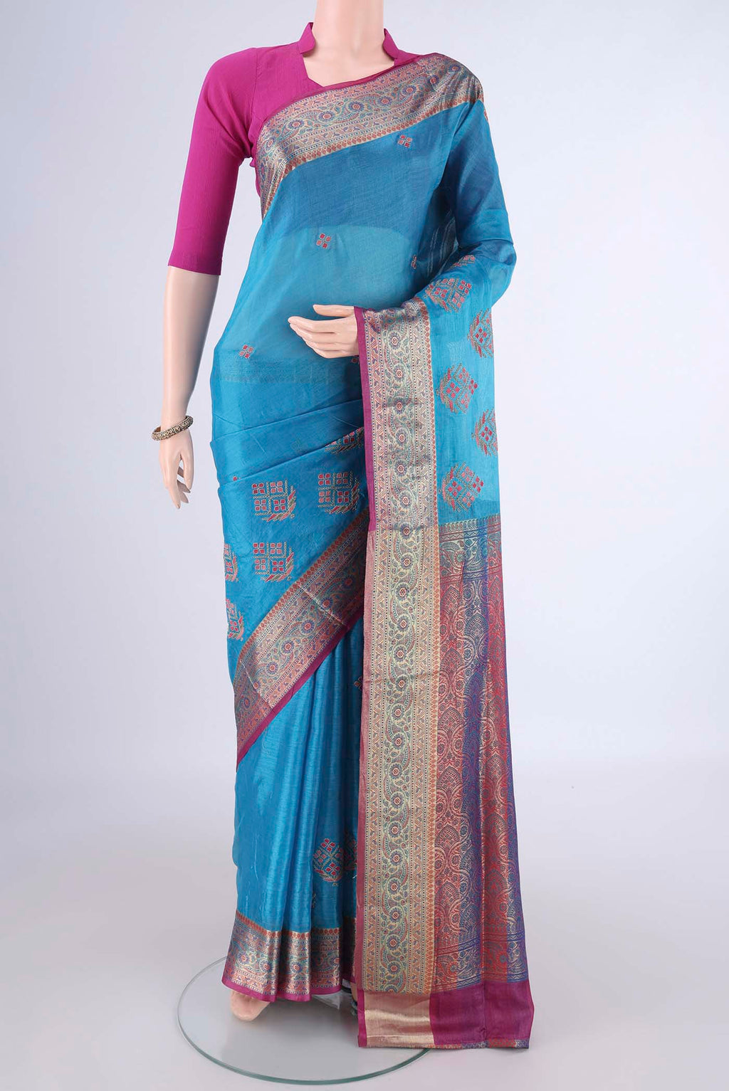 Blue Banarasi Tussar Silk Saree with Embroidery on the body and Zari Border.  displayed on a mannequin