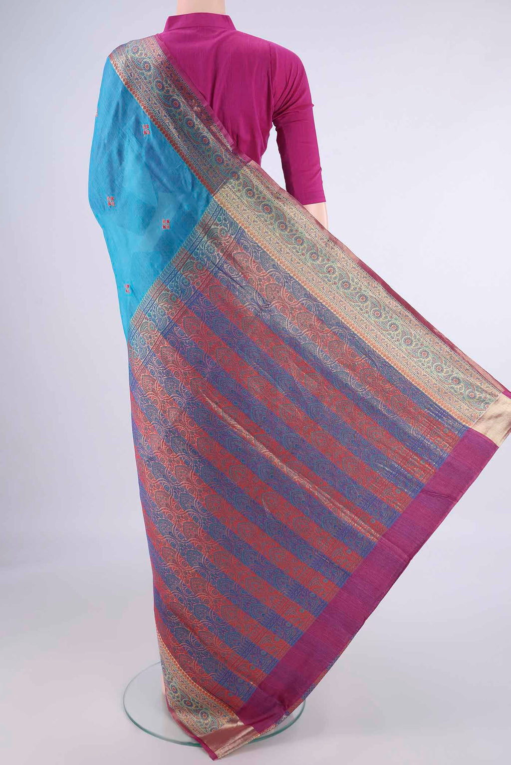 Flat view of Blue Banarasi Tussar Silk Saree with Embroidery on the body and Zari Border. 