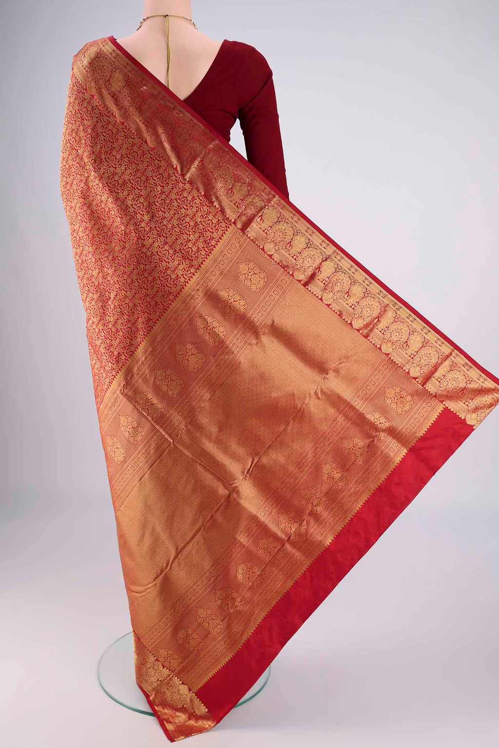 Flat view of Maroon Bangalore Silk Saree with Zari Brocade on the body and Zari Border. 