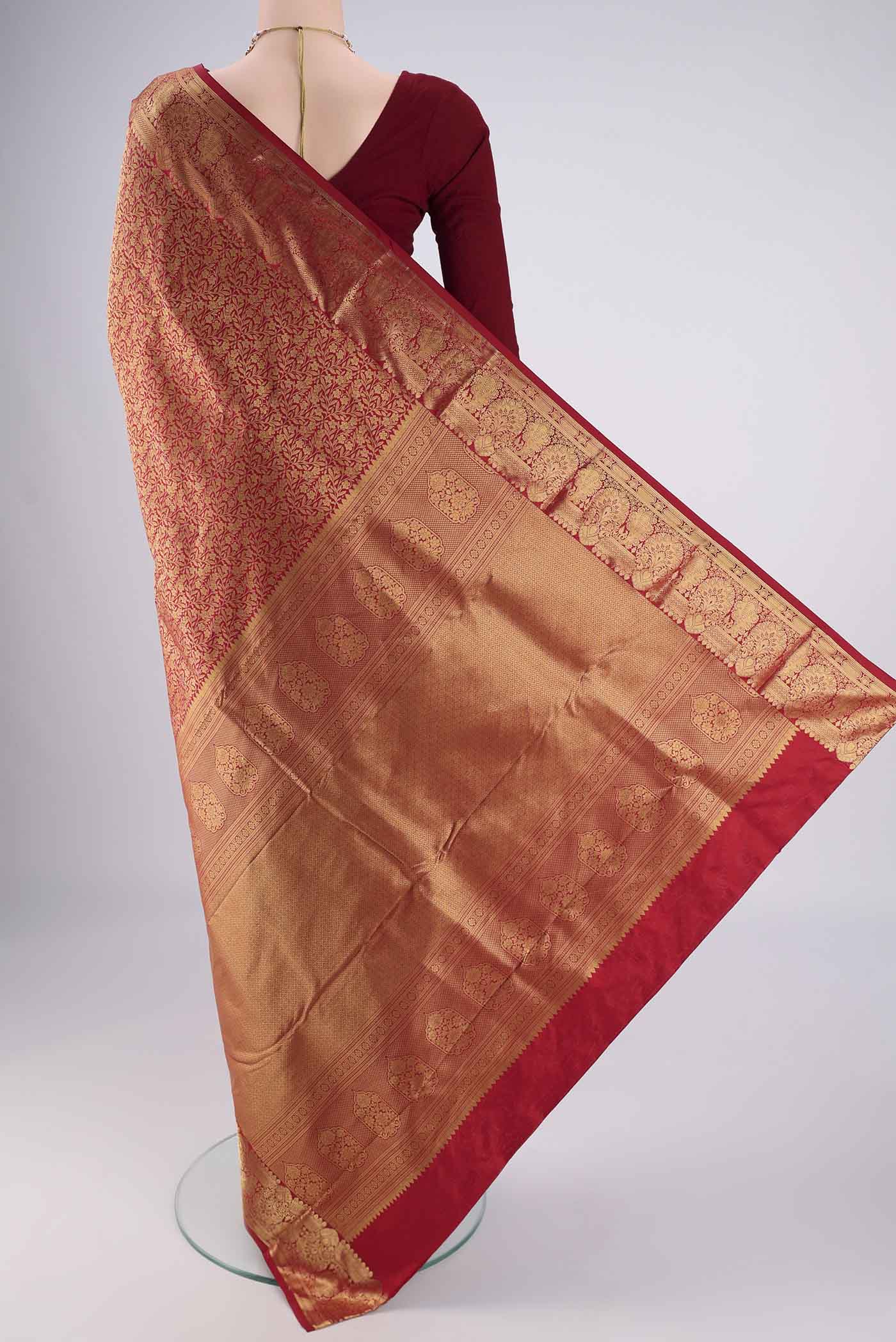 Flat view of Maroon Bangalore Silk Saree with Zari Brocade on the body and Zari Border. 