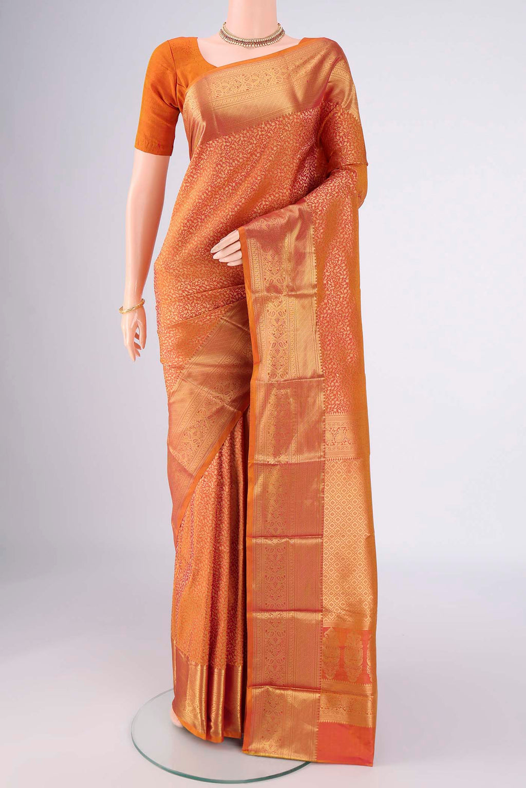 Brick Orange Dual Tone Bangalore Silk Saree with Zari Brocade on the body and Zari Border.  displayed on a mannequin