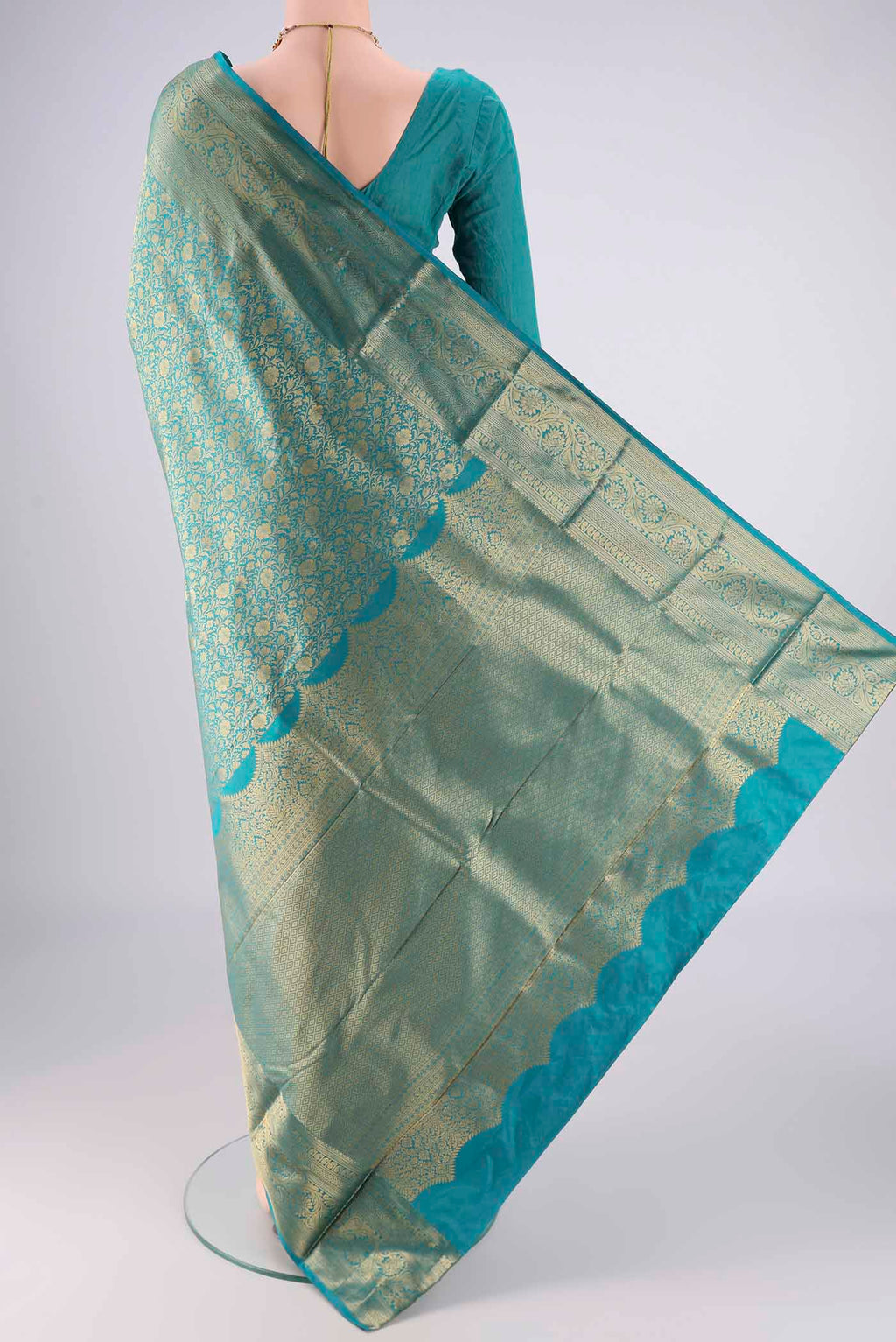 Flat view of Turquoise Bangalore Silk Saree with Zari Brocade on the body and Zari Border. 