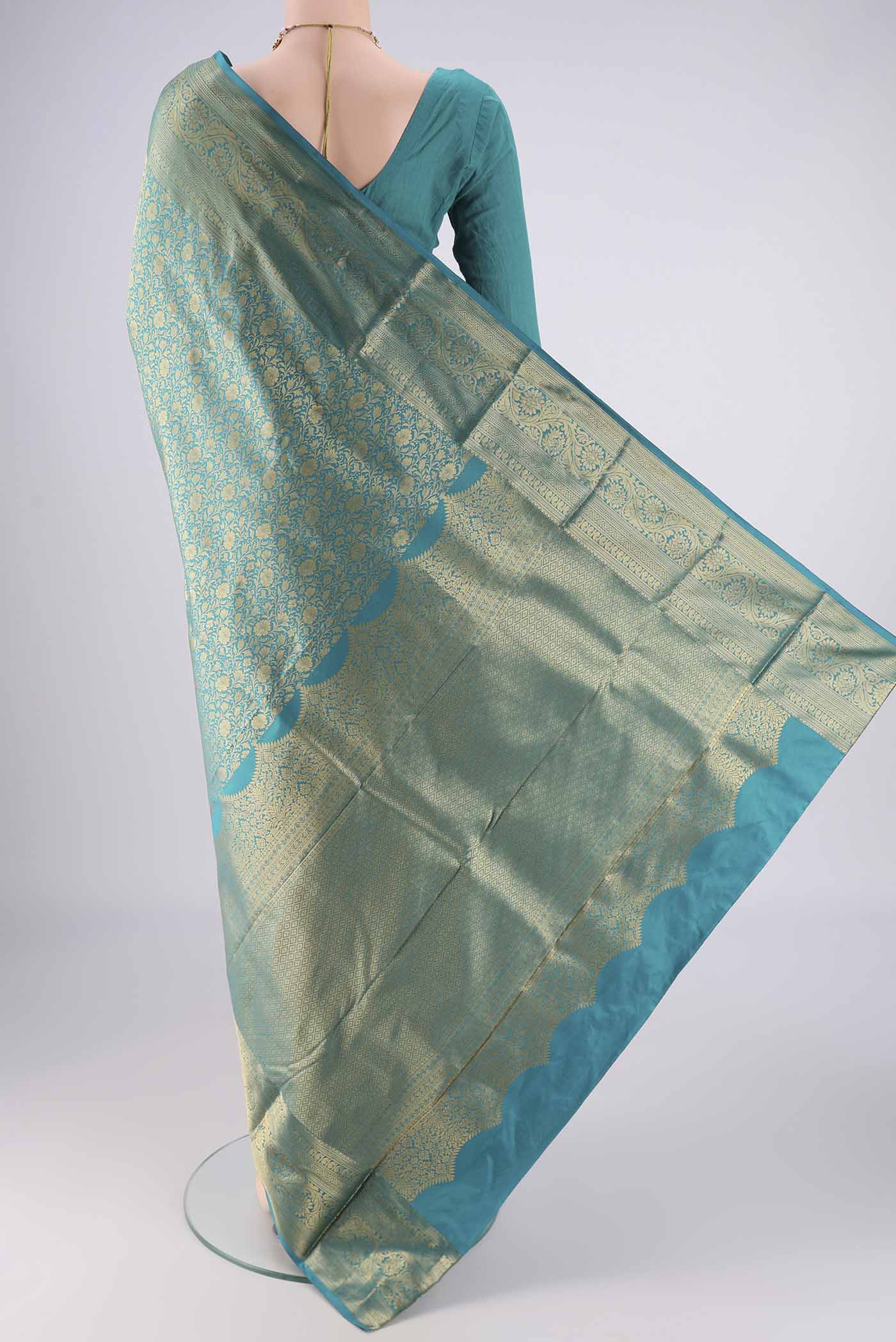 Flat view of Turquoise Bangalore Silk Saree with Zari Brocade on the body and Zari Border. 