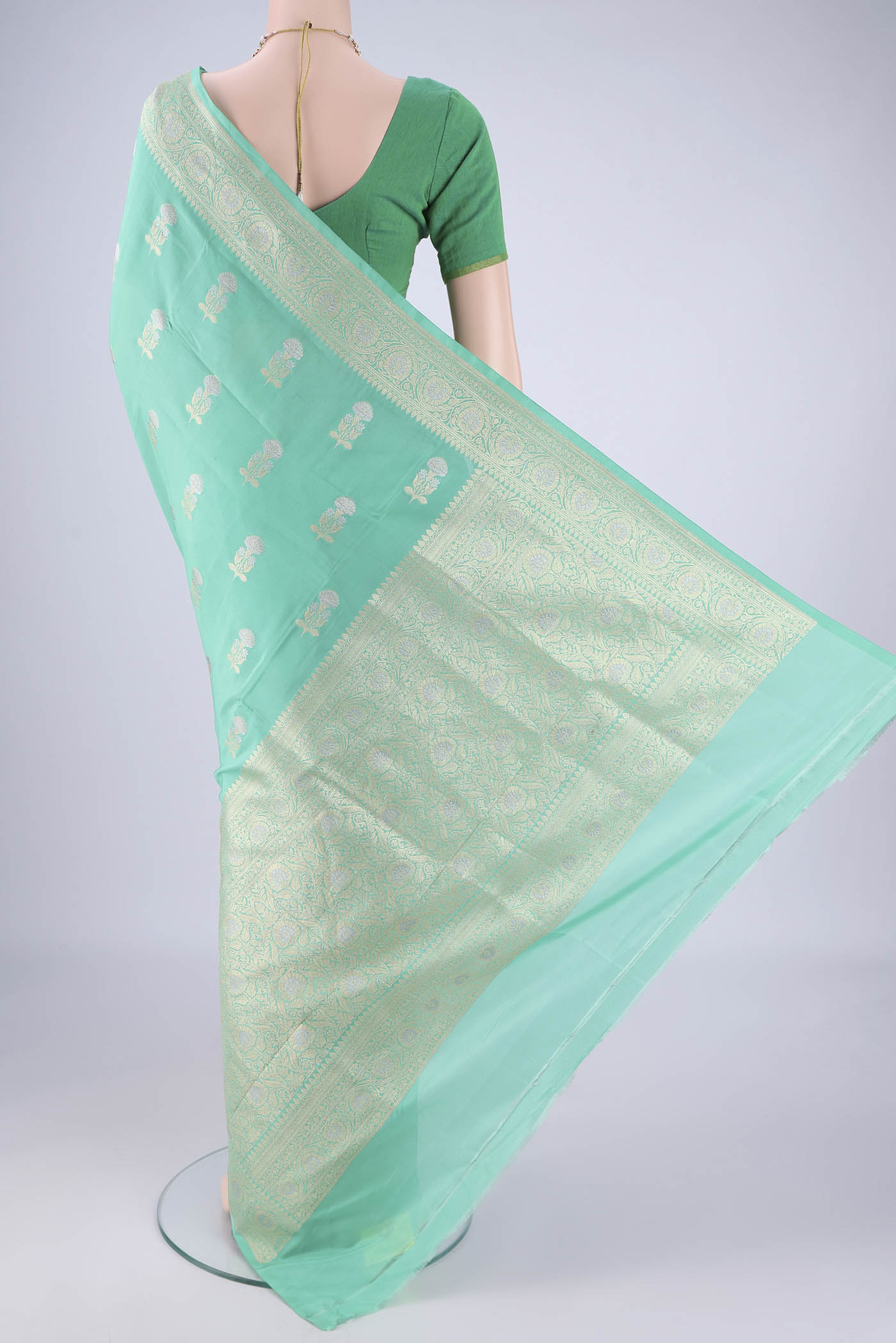 Flat view of Sea Green Banarasi Silk Saree with Zari Butta on the body and Zari Border. 