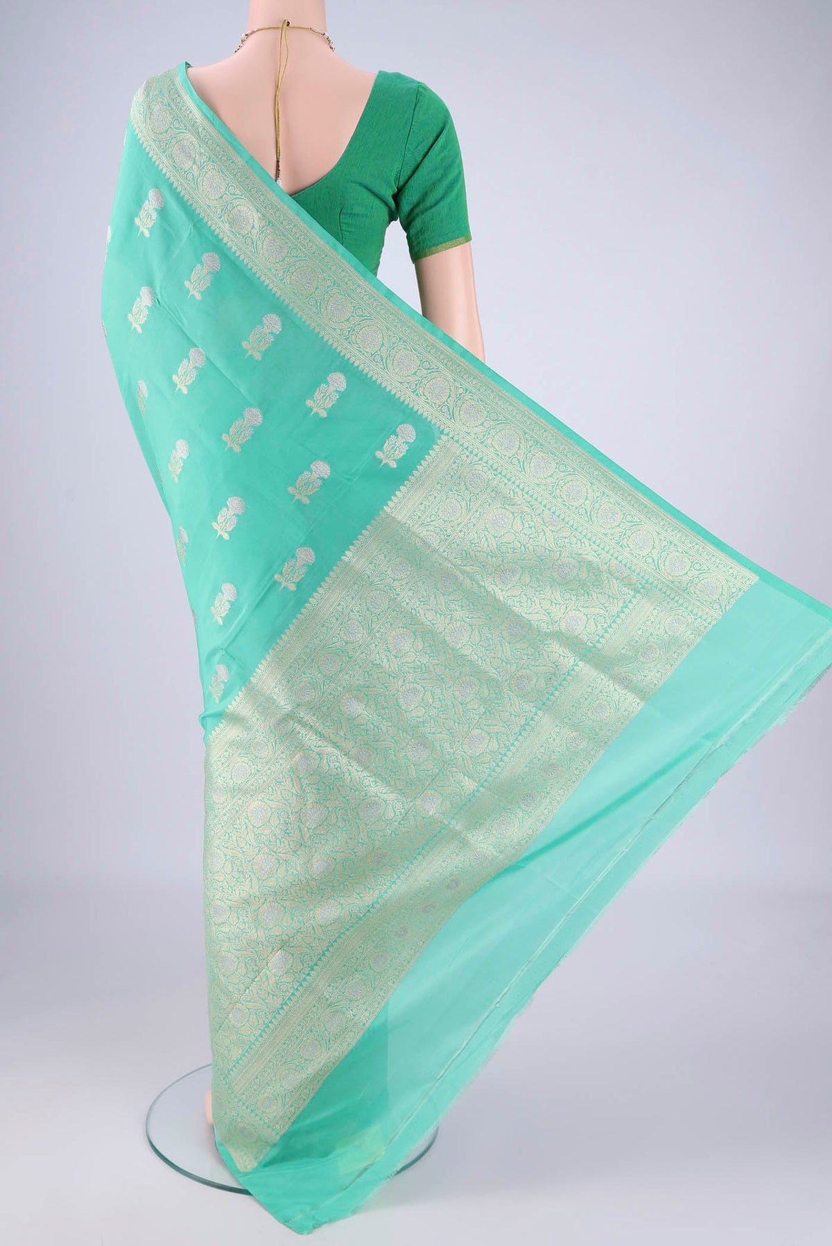 Flat view of Sea Green Banarasi Silk Saree with Zari Butta on the body and Zari Border. 