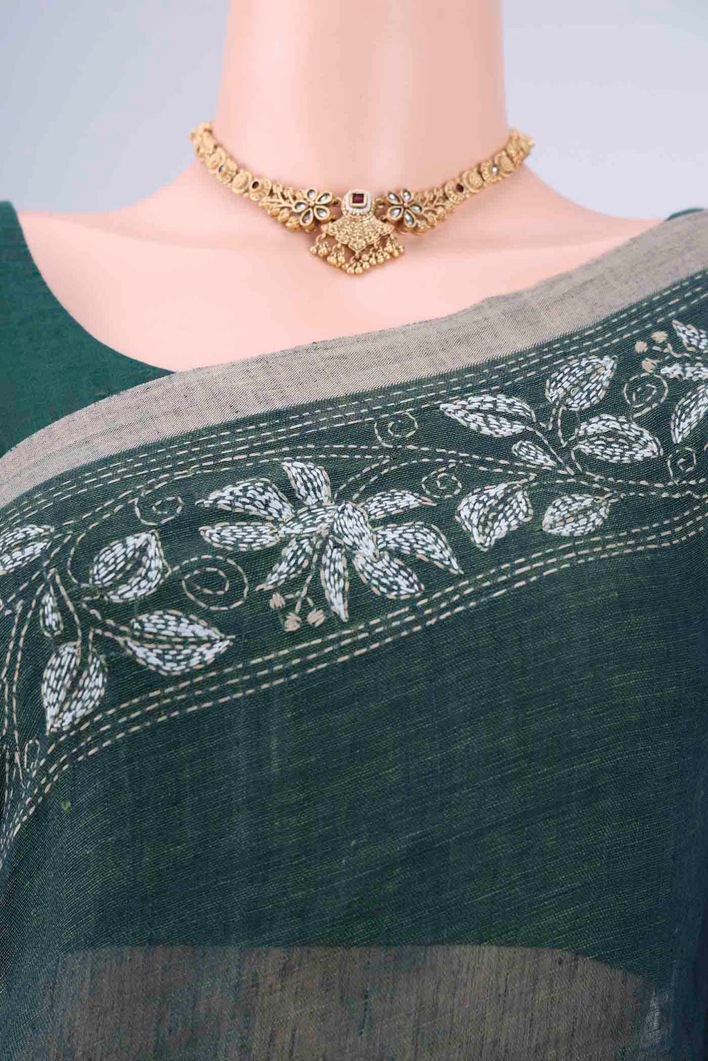 Border image of Olive Green Linen Cotton Saree with Kantha Work on the body and Thread Border. 