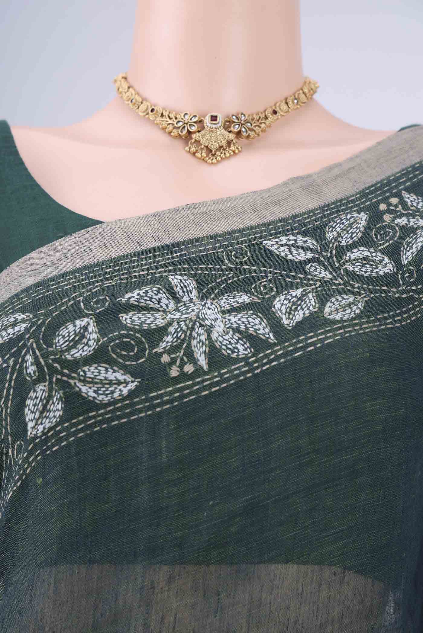 Border image of Olive Green Linen Cotton Saree with Kantha Work on the body and Thread Border. 