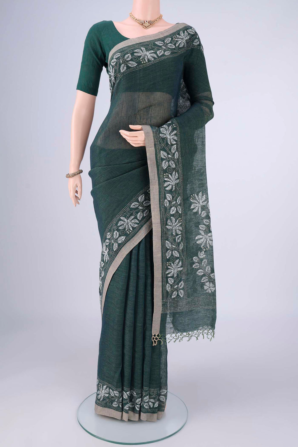 Olive Green Linen Cotton Saree with Kantha Work on the body and Thread Border.  displayed on a mannequin
