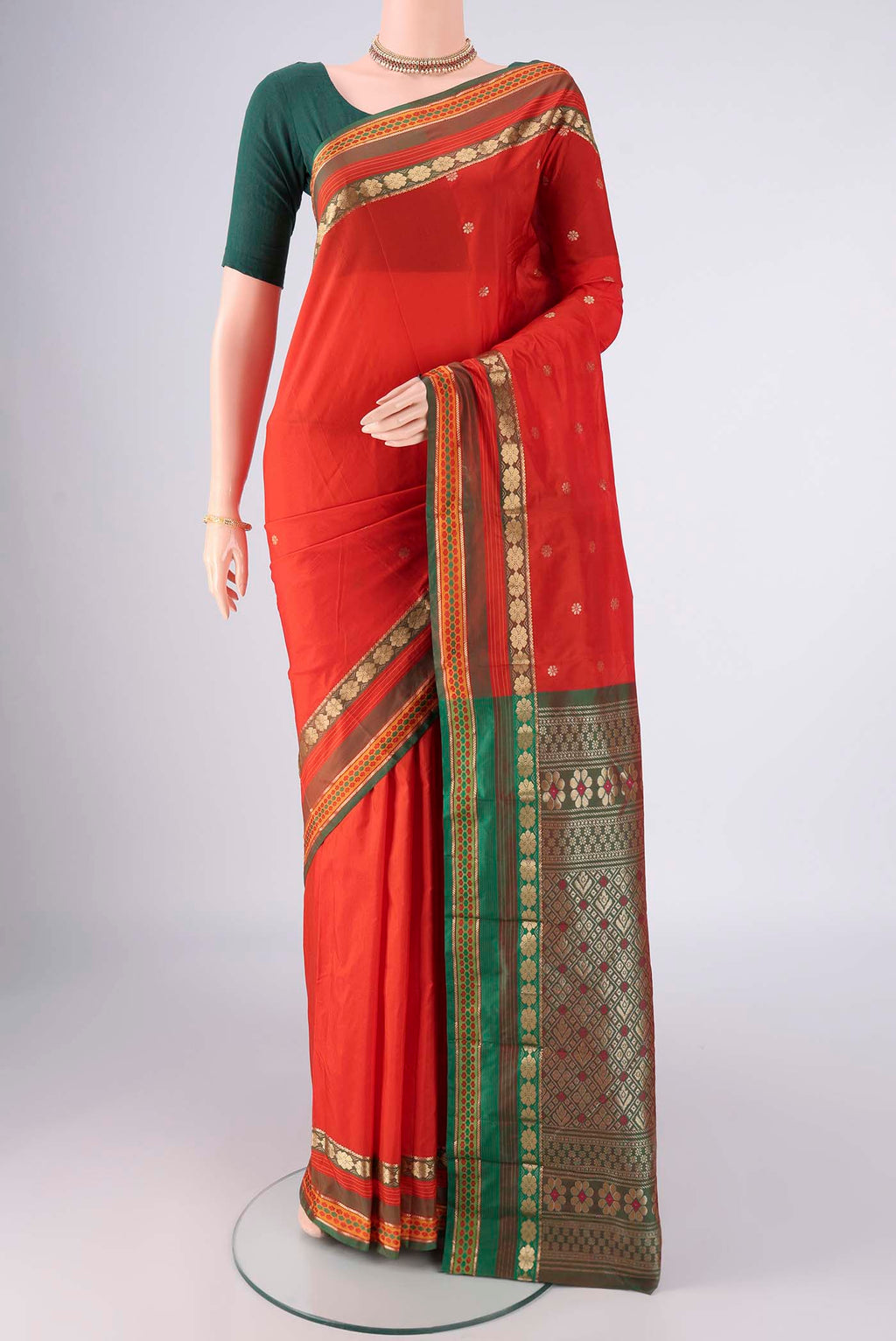 Orange Blended Bangalore Silk Saree with Zari Butta on the body and Zari Border.  displayed on a mannequin
