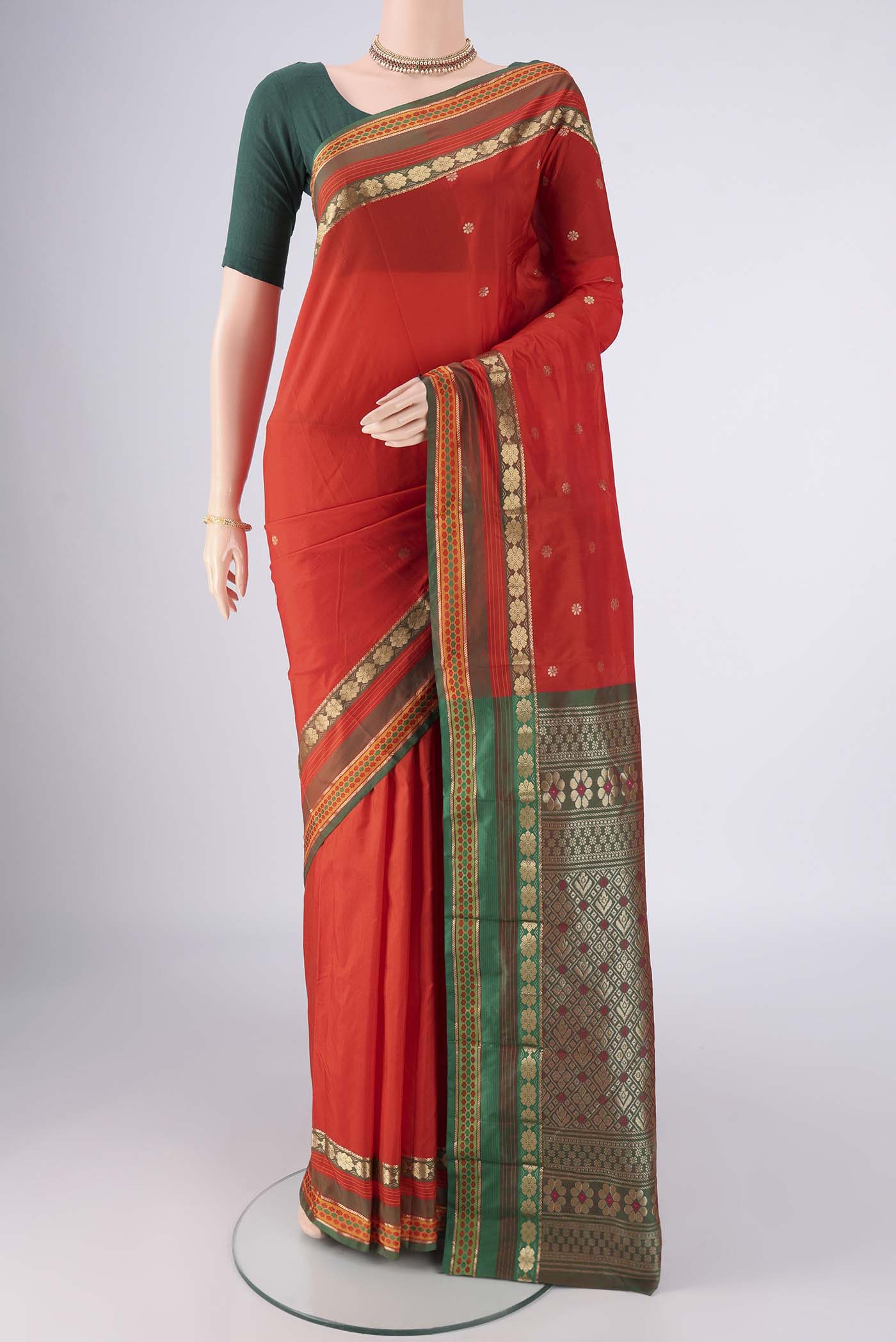Orange Blended Bangalore Silk Saree with Zari Butta on the body and Zari Border.  displayed on a mannequin