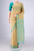 Beige Kanjivaram Silk Saree with Zari Butta on the body and One Side Border.  displayed on a mannequin