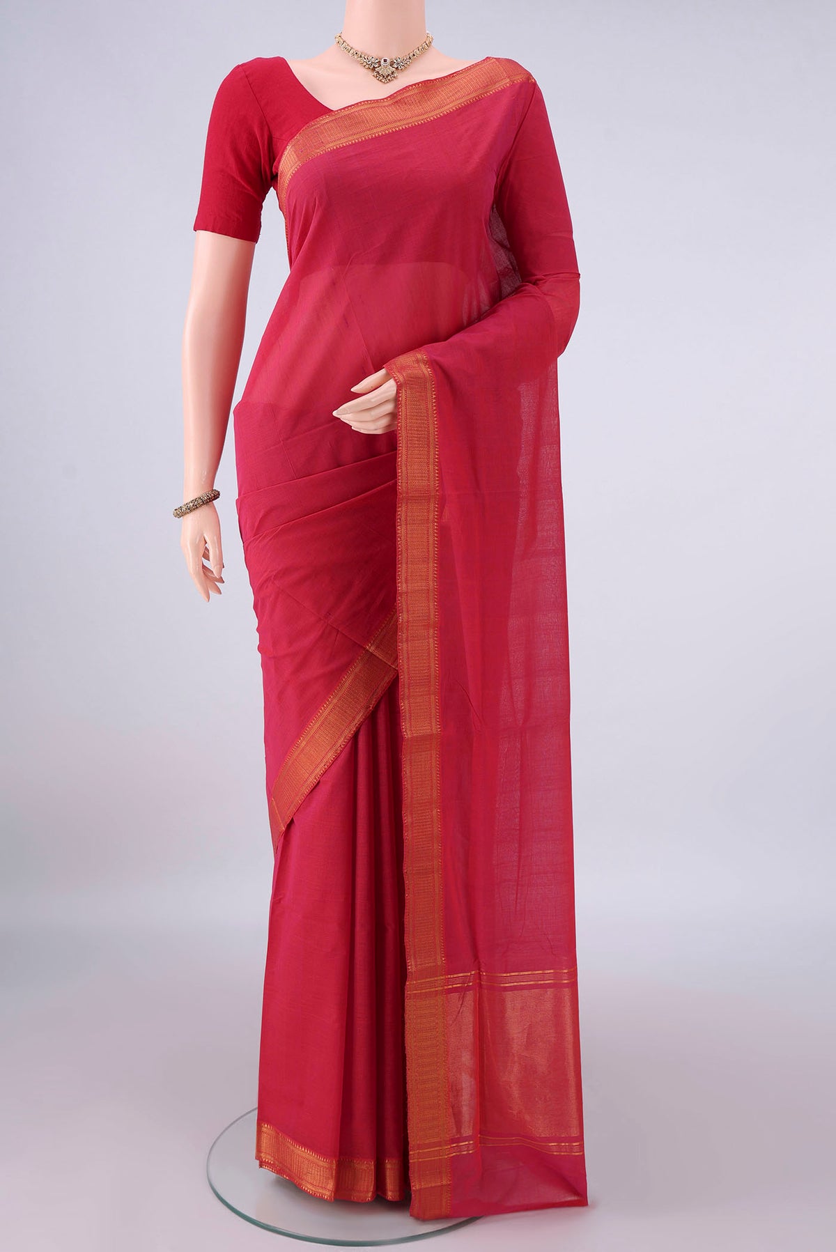 Coral Mangalagiri Cotton Saree with Plain Body and Zari Border.  displayed on a mannequin