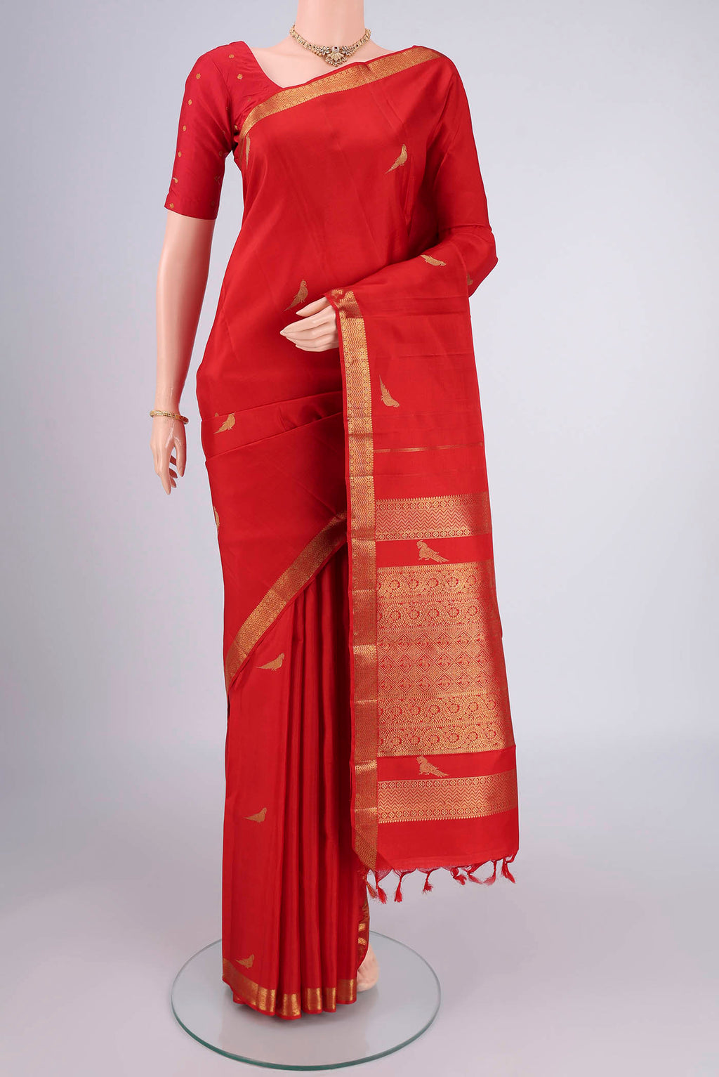 Pure Silk Pure Zari Deep Red Kanjivaram Saree with Zari Butta on the body and Zari Border.  displayed on a mannequin