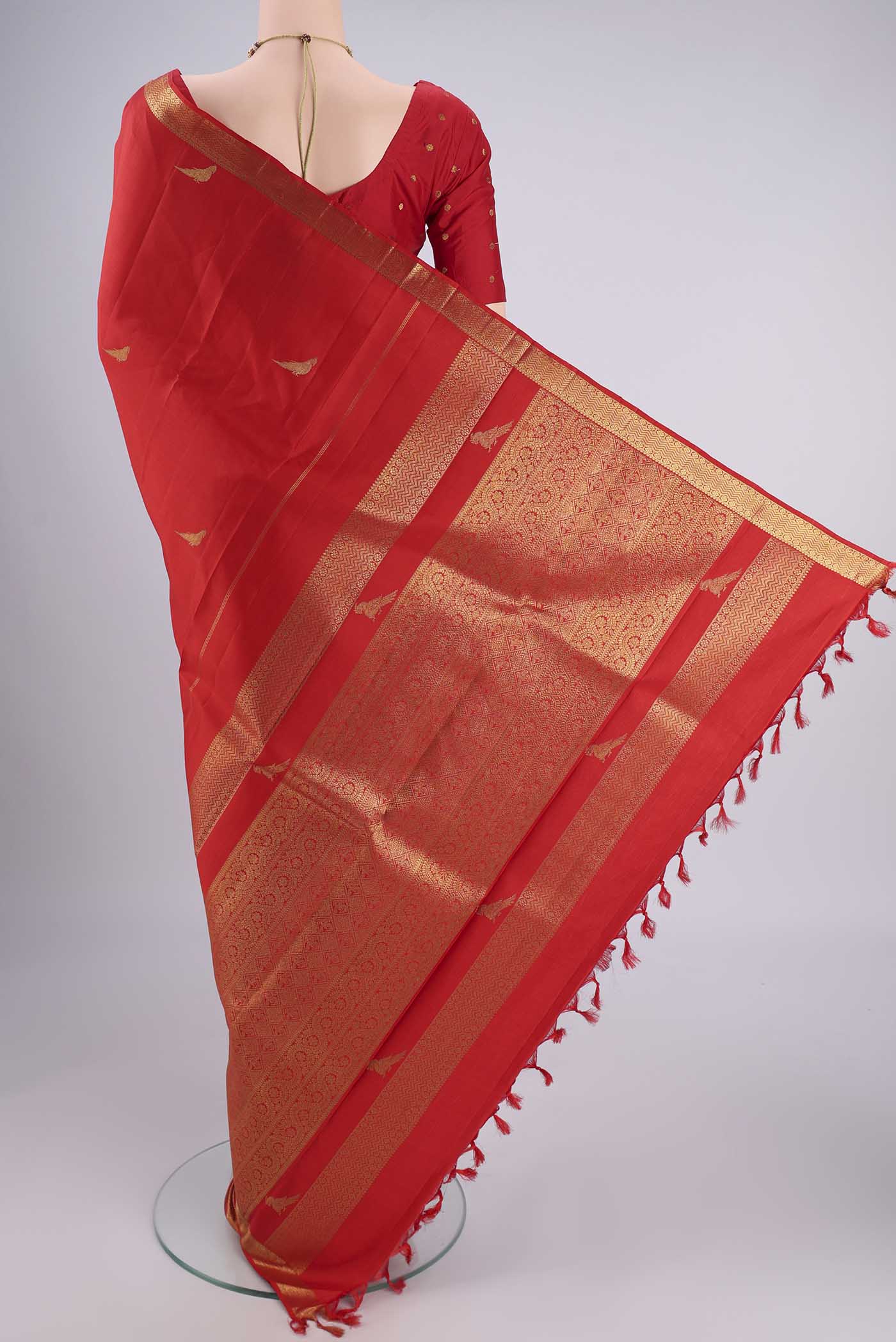 Flat view of Pure Silk Pure Zari Deep Red Kanjivaram Saree with Zari Butta on the body and Zari Border. 