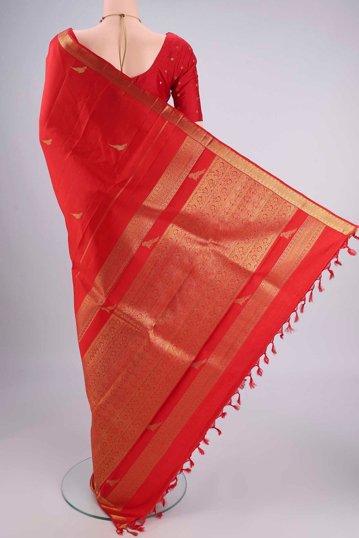 Flat view of Pure Silk Pure Zari Deep Red Kanjivaram Saree with Zari Butta on the body and Zari Border. 