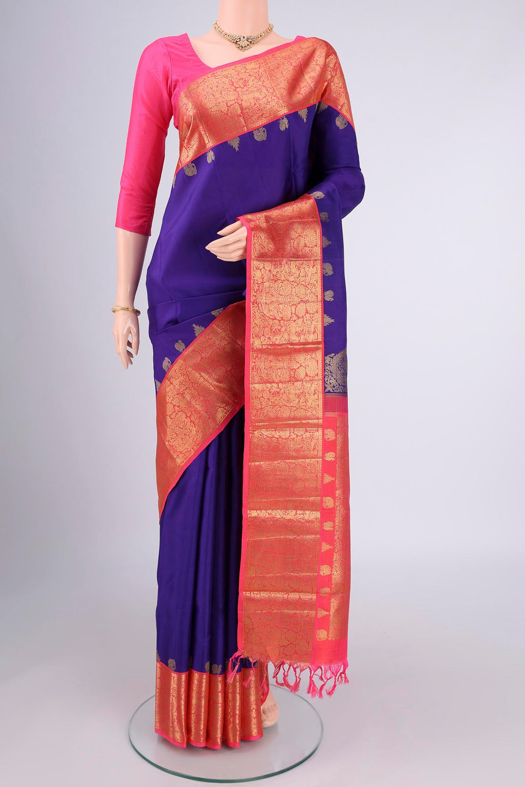 Pure Silk Pure Zari Violet Kanjivaram Saree with Zari Butta on the body and Zari Border.  displayed on a mannequin