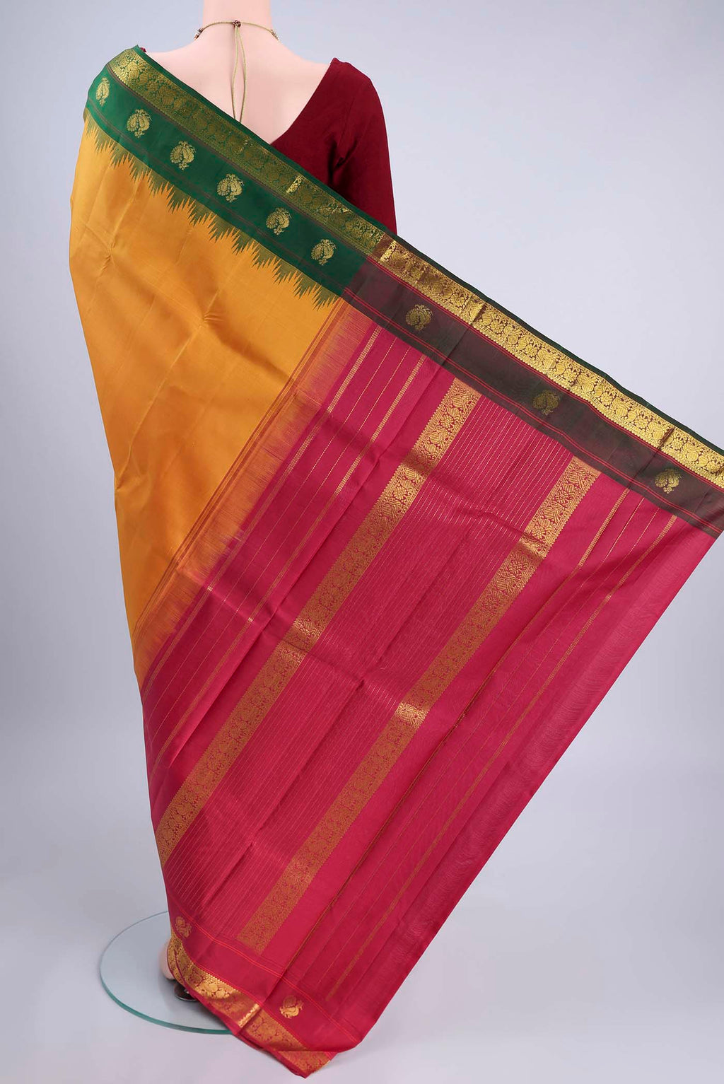 Flat view of Pure Silk Pure Zari Mustard Kanjivaram Saree with Plain Body and Ganga Jamuna Border. 