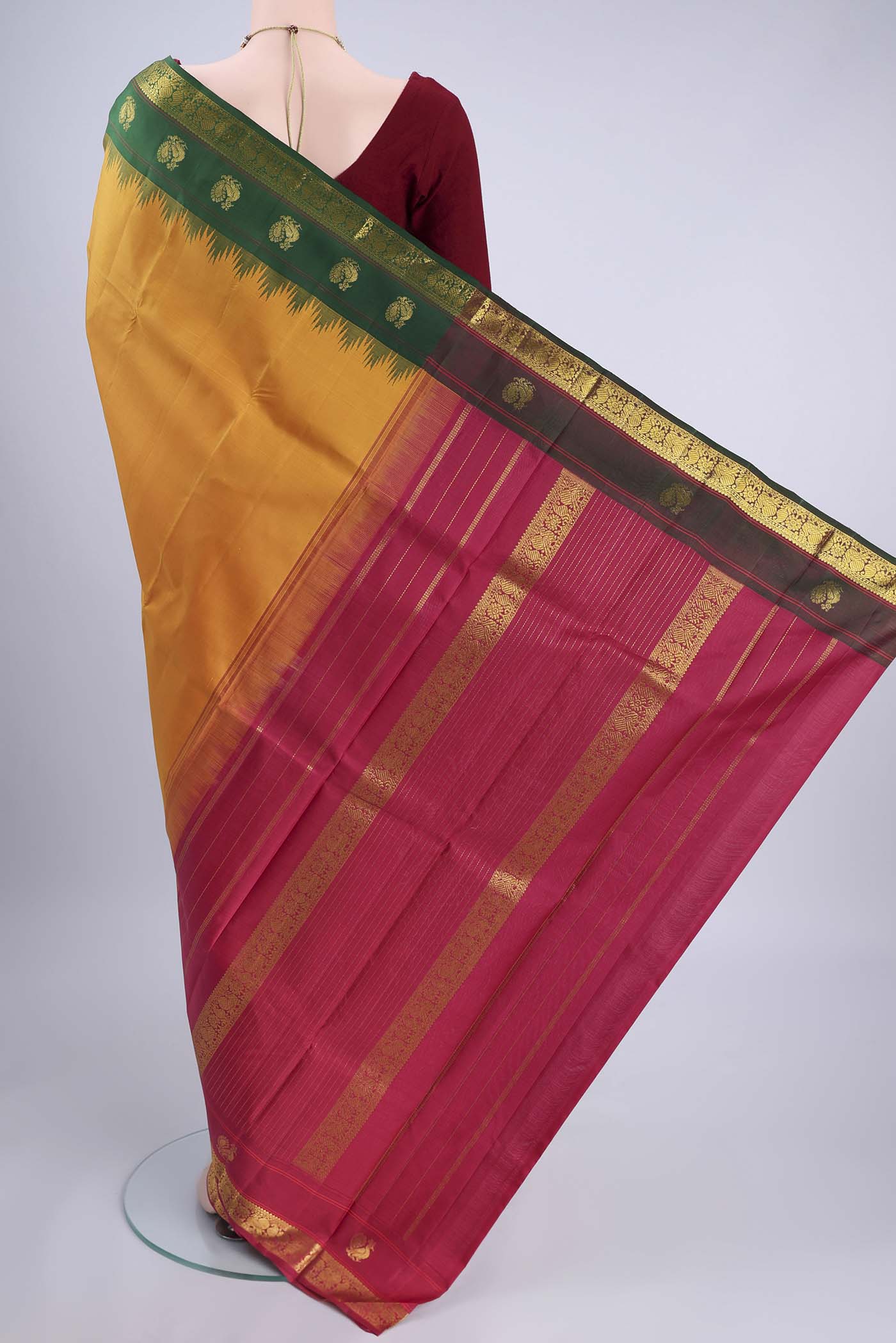 Flat view of Pure Silk Pure Zari Mustard Kanjivaram Saree with Plain Body and Ganga Jamuna Border. 