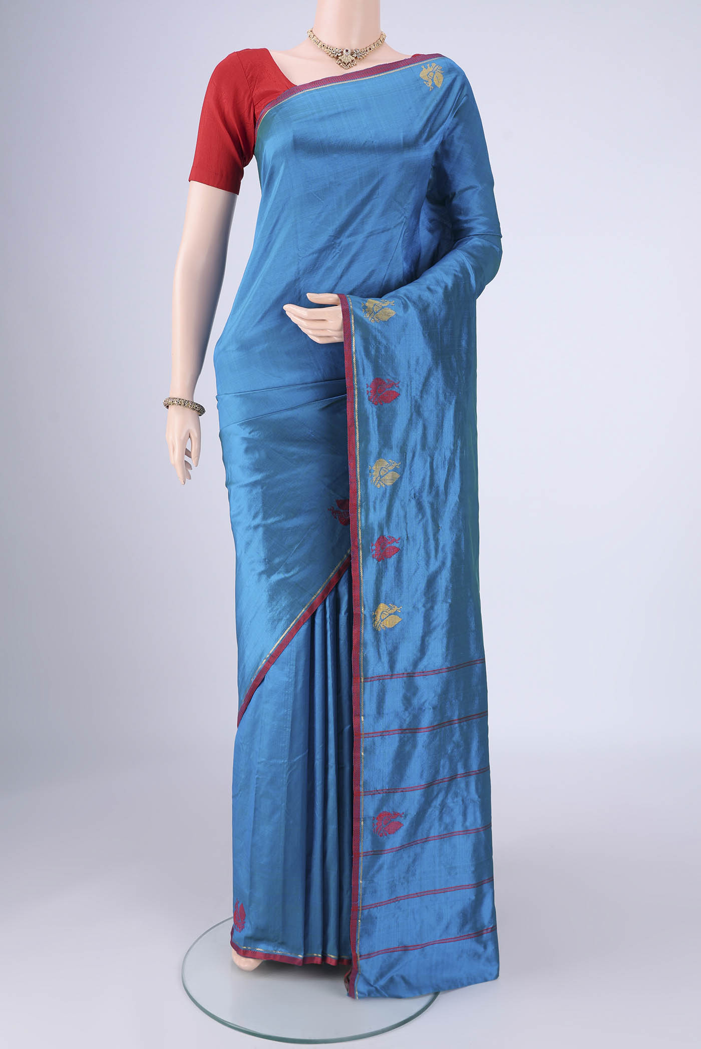 Blue Kanchipuram Silk Saree with Plain Body and Zari And Thread Border.  displayed on a mannequin