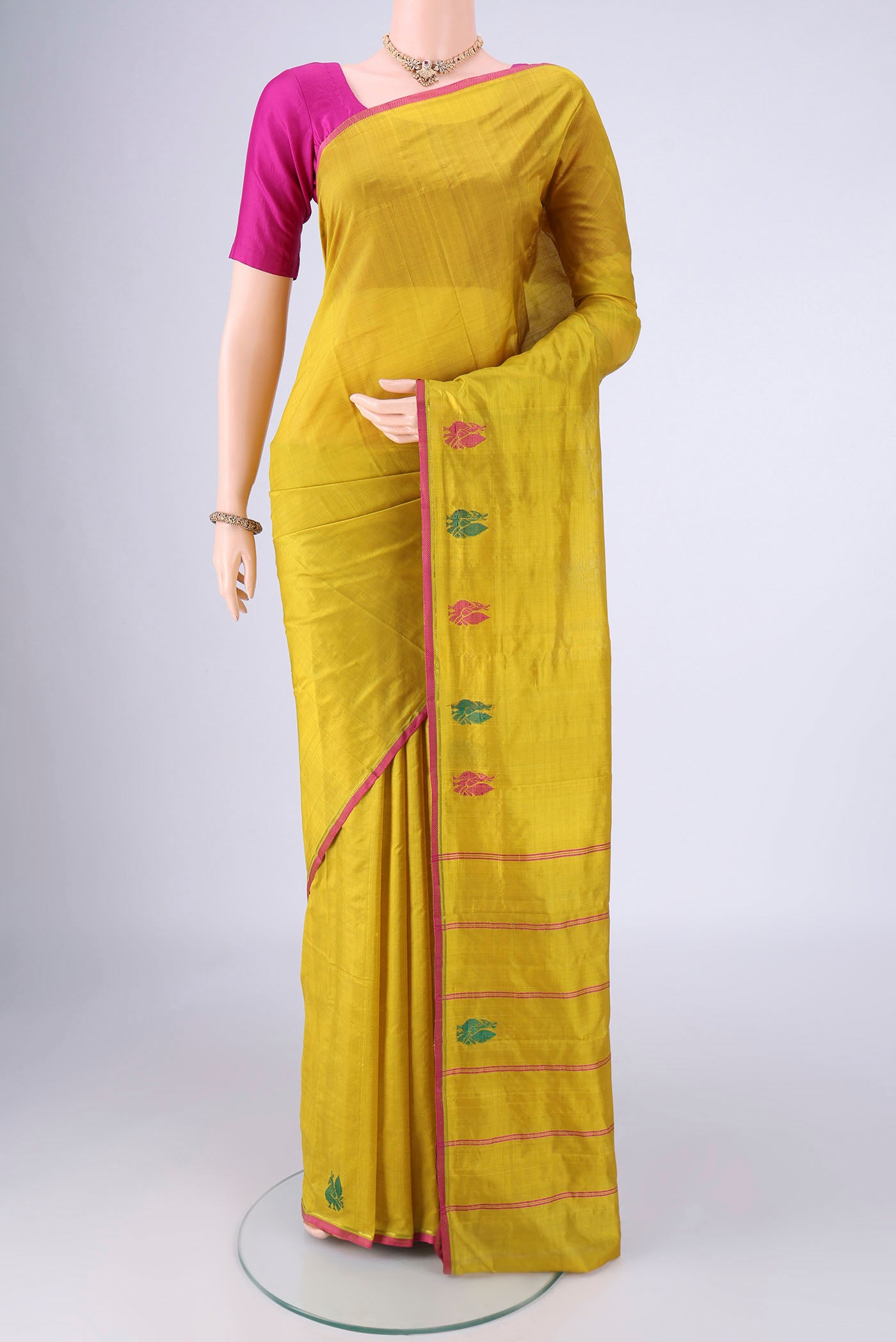 Acid Green Kanchipuram Silk Saree with Plain Body and Zari And Thread Border.  displayed on a mannequin